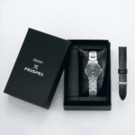 Seiko PROSPEX watch in elegant packaging with teal dial, stainless steel bracelet, and leather strap.