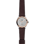 Elegant Tudor watch with rose gold bezel, silver sunburst dial, and brown leather strap.