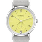NOMOS Glashüttes vibrant yellow dial wristwatch with stainless steel case and gray textile strap.