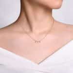 Elegant gold necklace with dangling pendants on a model, perfect for any occasion.
