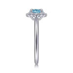 Elegant blue topaz halo ring in silver, showcasing exquisite craftsmanship and timeless sophistication.