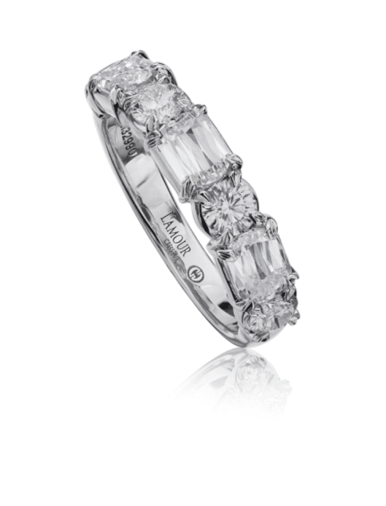 Elegant diamond ring with radiant and round cut stones in a polished platinum setting.