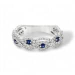 Elegant sterling silver wave ring with blue sapphires and white diamonds, perfect for any occasion.