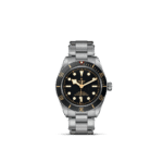 Tudor diving watch features a black dial, vintage beige accents, and robust stainless steel bracelet.