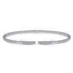 Elegant silver bracelet with round beads and textured ends, perfect for any occasion.