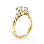 Elegant yellow gold engagement ring featuring a large round diamond and pear-shaped accents.