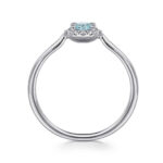 Elegant light blue gemstone ring with shimmering accents in polished white gold or platinum.