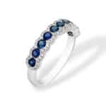 Elegant blue sapphire ring in polished white metal, perfect for any occasion.