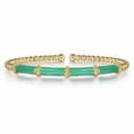 Elegant green stone cuff bracelet with intricate golden accents, perfect for any occasion.