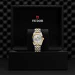 Elegant Tudor watch in luxury black box showcasing timeless design and quality craftsmanship.