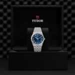 Luxurious Tudor wristwatch with blue dial presented in an elegant box, showcasing timeless craftsmanship.
