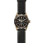 Tudor bronze diving watch with black ceramic bezel and leather strap for stylish functionality.