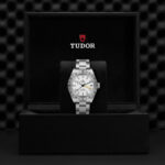 Elegantly displayed Tudor watch in luxurious presentation box, showcasing timeless design and quality craftsmanship.