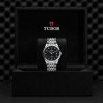 Luxurious Tudor watch in elegant black box with striking black dial and refined design.