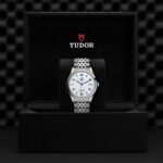 Tudor watch displayed in a luxurious box, showcasing elegance and exceptional craftsmanship.
