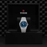 Luxury Tudor watch with blue dial in an elegant presentation box, showcasing exquisite craftsmanship.