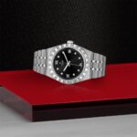 Stylish luxury watch with silver bracelet, black dial, and diamond markers against a textured background.
