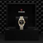 Tudor watch in luxurious box showcases elegance, craftsmanship, and timeless style.