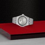 Tudor watch on a red display, showcasing luxury, elegance, and fine craftsmanship details.
