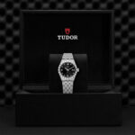 Elegant Tudor watch in a luxurious black presentation box, showcasing timeless craftsmanship and style.