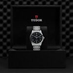 Elegant Tudor watch in luxurious black box showcases timeless craftsmanship and sophisticated design.