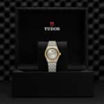 Elegant Tudor watch in luxurious display box, featuring a two-tone stainless steel and gold design.