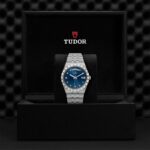 Elegant Tudor watch with a blue dial in a luxurious display box.