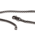 Elegant black metal chain with intricate dragon clasp, showcasing detailed craftsmanship and durability.