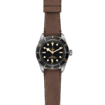Elegant Tudor dive watch with black dial, gold accents, and brown leather strap.