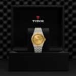 Luxurious Tudor watch in elegant packaging with gold dial and sophisticated design features.