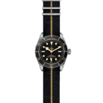 Tudor dive watch with matte black dial and gold accents, combining elegance and durability.
