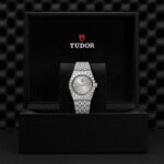Elegant Tudor watch in luxurious black box, showcasing timeless craftsmanship and sophisticated design.