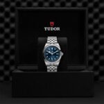 TUDOR luxury watch in elegant black presentation box with polished stainless steel and blue dial.