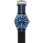 Tudor Pelagos diving watch features a blue dial, stainless steel case, and rugged fabric strap.