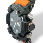 Durable G-SHOCK watch in black and orange with analog-digital features and flexible strap.