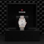 Tudor watch in luxurious black box features stainless steel and rose gold design with a silver dial.