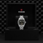 Tudor watch in elegant packaging, showcasing luxury design and craftsmanship, ideal for travelers.