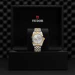 Elegant Tudor watch in black box with silver and gold accents, perfect for collectors.