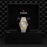 Elegant Tudor watch in luxury presentation box with silver and gold tones, perfect for any occasion.