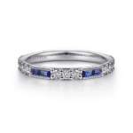 Elegant white gold ring with diamonds and blue sapphires, perfect for engagement or special occasions.