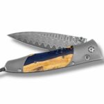 Elegant folding knife with damascus steel blade and wooden handle, perfect for collectors and outdoor enthusiasts.