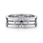 Contemporary interlocking ring in polished metal with geometric design and layered textures.