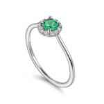 Emerald halo ring by Gabriel & Co., featuring sparkling gemstones and elegant white gold band.