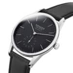 Elegant Nomos Glashütte watch with black dial and leather strap, showcasing minimalist luxury design.