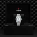 Luxury Tudor watch in elegant box with light blue dial and stainless steel bracelet.