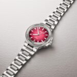 Oris luxury watch features a vibrant red dial with stainless steel bezel and bracelet.