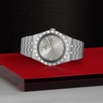 Luxurious Tudor wristwatch with diamond markers on polished silver stainless steel and a stylish backdrop.