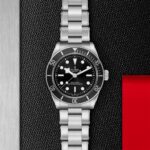Stainless steel Tudor diving watch with black dial, luminous markers, and water resistance up to 200 meters.