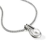 Elegant pearl necklace with braided silver chain and modern clasp design.
