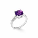Elegant silver ring featuring a stunning oval amethyst gemstone and sparkling accent stones.